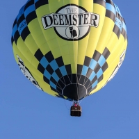 Hot air balloon taking off from across the road