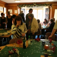 Doug, the chef & manager, adjusts the table settings, while Rosemary seizes on a glass of wine