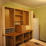 The dresser area and fridge.